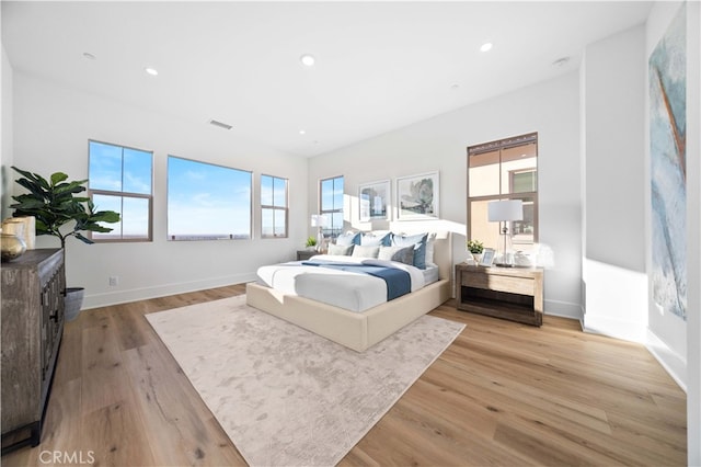 bedroom with baseboards, visible vents, light wood-style floors, and recessed lighting