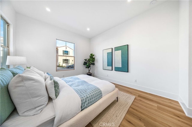 bedroom featuring baseboards, recessed lighting, and light wood-type flooring