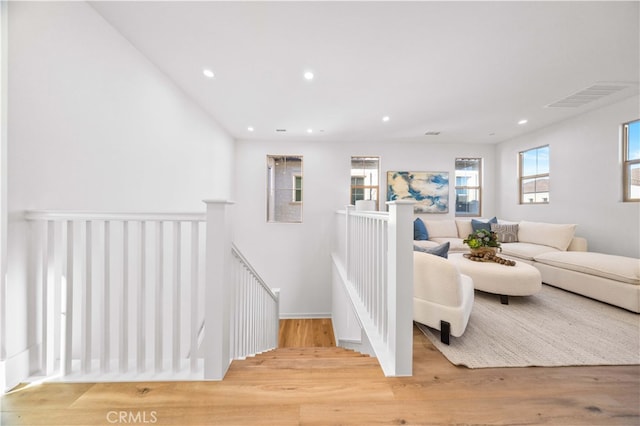 stairway with visible vents, recessed lighting, and wood finished floors
