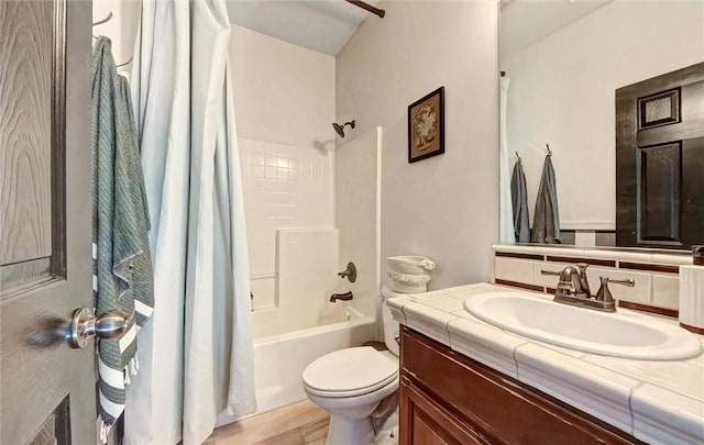 bathroom with vanity, wood finished floors, shower / tub combo with curtain, toilet, and backsplash