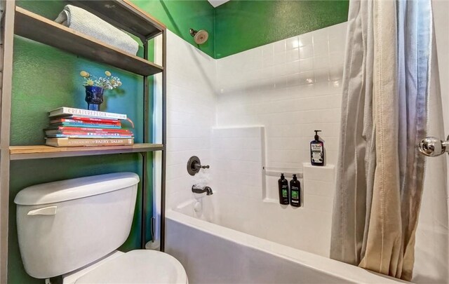 bathroom with toilet and shower / bathtub combination with curtain