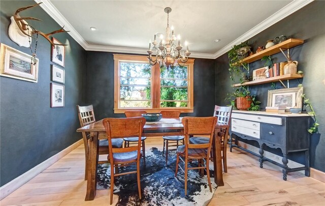 dining area featuring light wood-style flooring, baseboards, an inviting chandelier, and ornamental molding