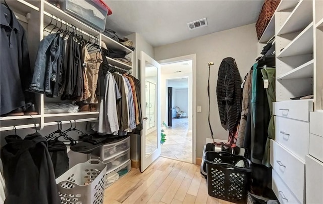 walk in closet featuring visible vents and wood finished floors