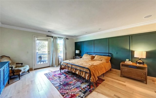 bedroom featuring access to exterior, visible vents, light wood-style floors, and ornamental molding