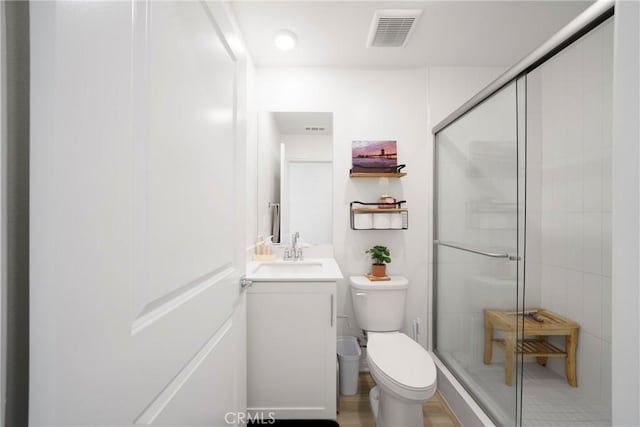 full bathroom featuring visible vents, toilet, and a shower stall