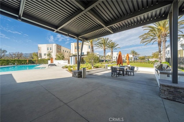 view of patio / terrace with area for grilling, outdoor dining space, and a community pool