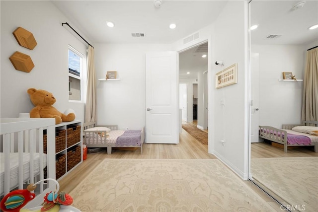 bedroom featuring recessed lighting, visible vents, and light wood-style flooring