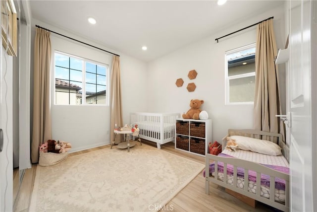 bedroom with recessed lighting and wood finished floors