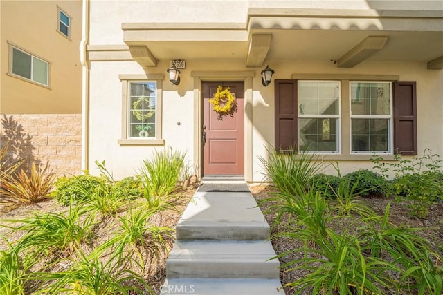 property entrance featuring stucco siding