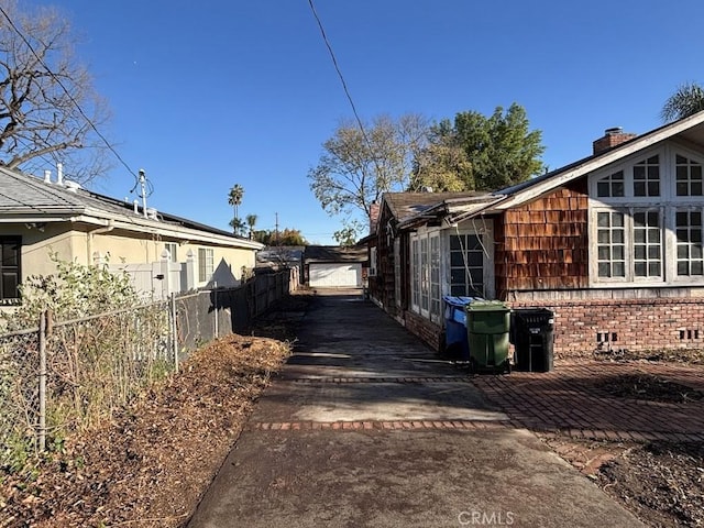 view of side of property featuring fence, brick siding, and crawl space