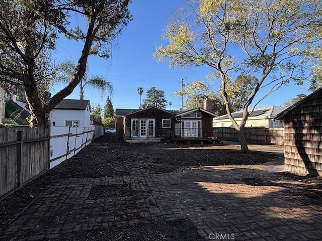 rear view of house featuring a fenced backyard