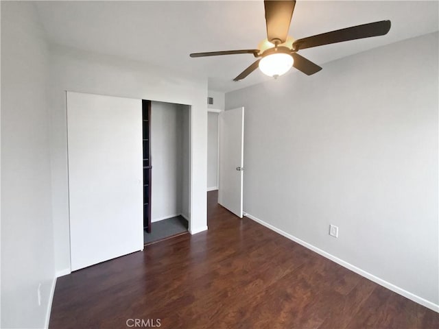 unfurnished bedroom with visible vents, ceiling fan, baseboards, wood finished floors, and a closet