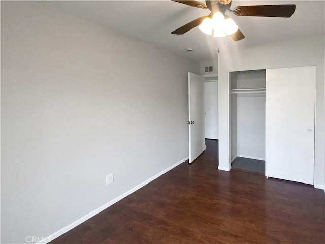 unfurnished bedroom with visible vents, wood finished floors, a closet, baseboards, and ceiling fan