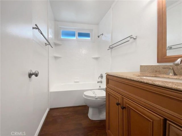 bathroom with baseboards, toilet, wood finished floors, vanity, and  shower combination