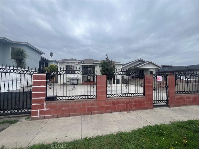 view of gate with a fenced front yard