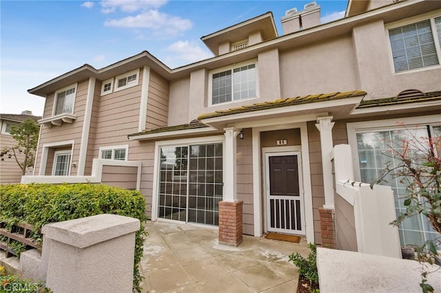 view of front of home with a patio area and stucco siding