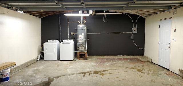 unfinished below grade area featuring washer and dryer and water heater