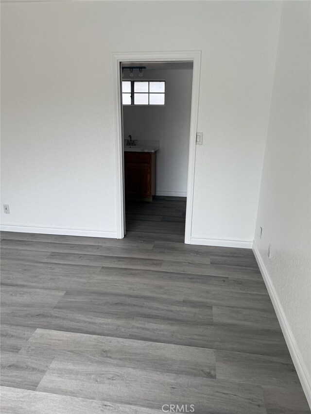 empty room with wood finished floors and baseboards