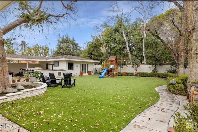 view of yard with a playground and fence