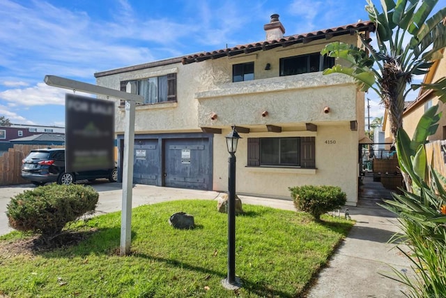 mediterranean / spanish-style home with stucco siding, a chimney, a garage, and fence