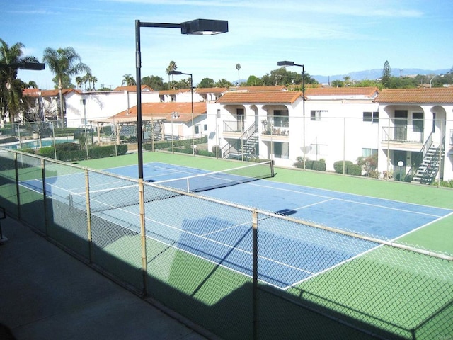 view of sport court with fence