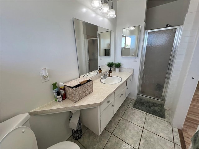 full bathroom featuring tile patterned floors, toilet, a stall shower, and vanity