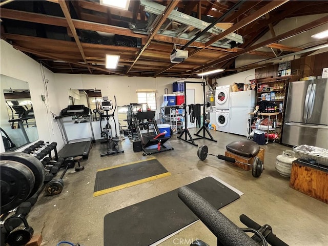 exercise room with a garage and stacked washer and clothes dryer