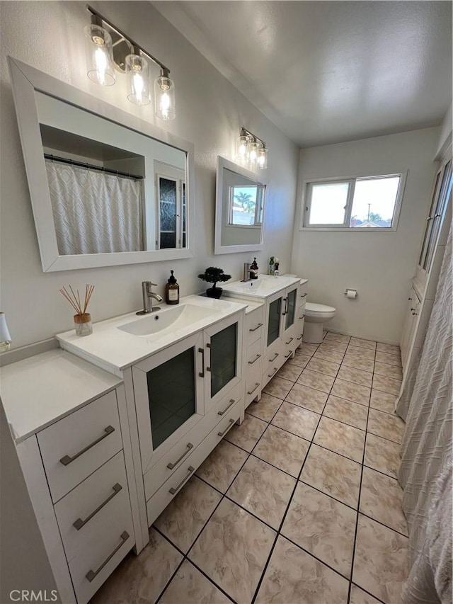 full bathroom with vanity, tile patterned floors, and toilet