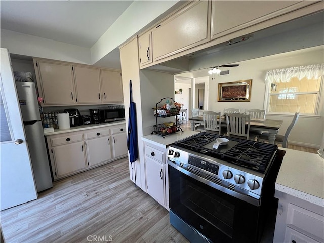 kitchen featuring light wood-style flooring, appliances with stainless steel finishes, and light countertops