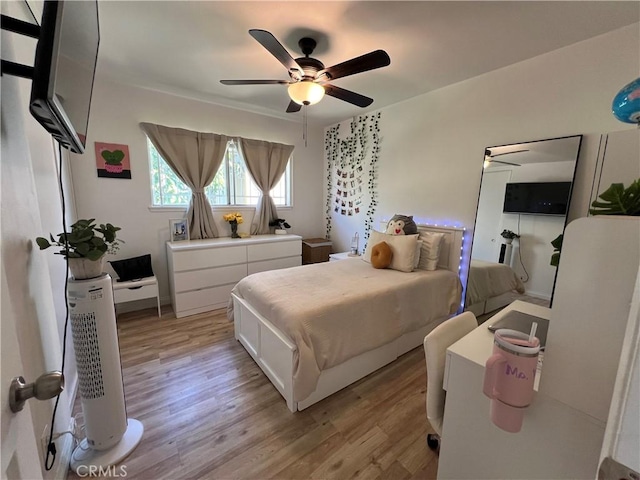 bedroom with a ceiling fan and light wood-style floors