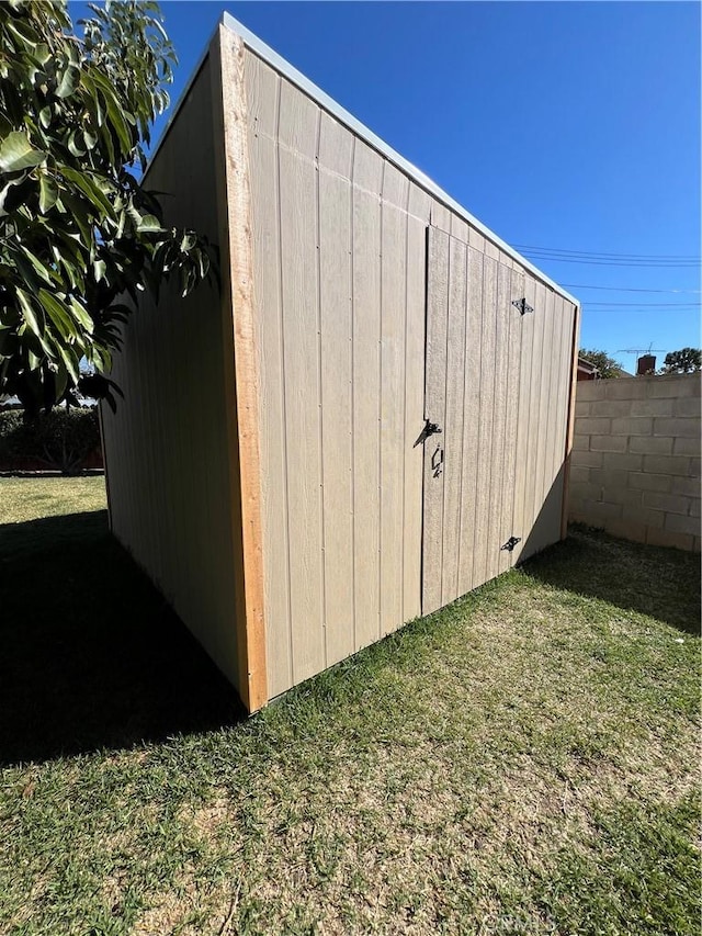 view of shed with fence