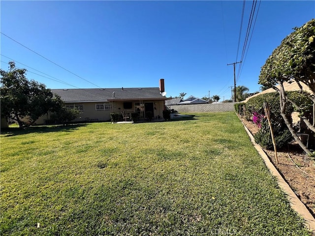 view of yard with a patio area and a fenced backyard