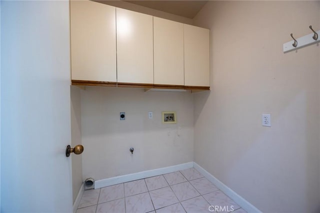 washroom with washer hookup, hookup for a gas dryer, cabinet space, baseboards, and hookup for an electric dryer