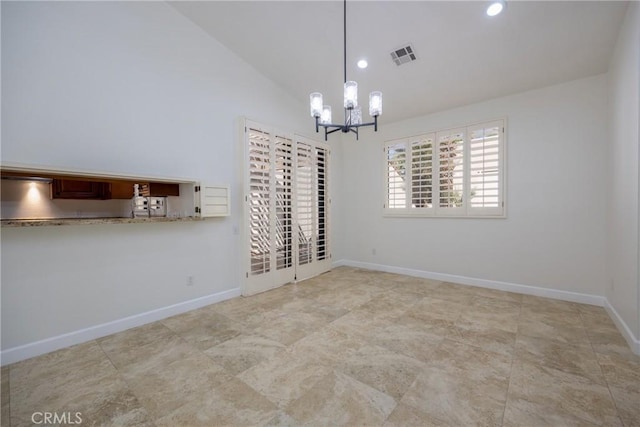 unfurnished dining area with visible vents, baseboards, high vaulted ceiling, an inviting chandelier, and recessed lighting