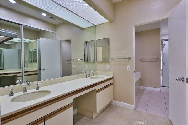 full bathroom featuring a sink, visible vents, double vanity, and tile patterned flooring