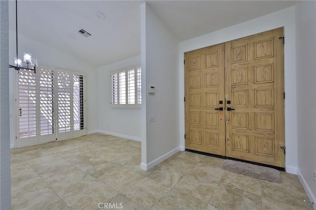 entryway with visible vents, baseboards, an inviting chandelier, and vaulted ceiling