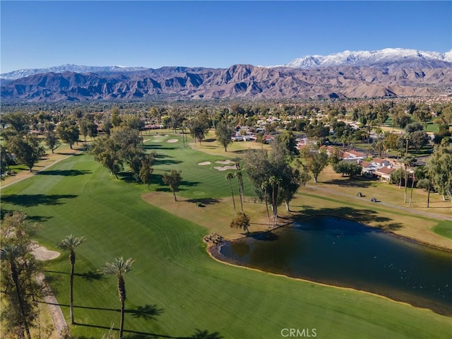 drone / aerial view with a water and mountain view and golf course view