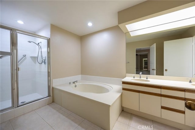 bathroom featuring a sink, a garden tub, a stall shower, and tile patterned flooring