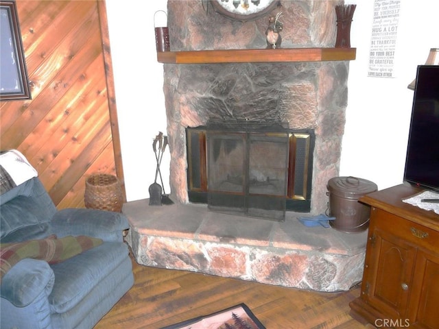 interior details with wood finished floors and a fireplace