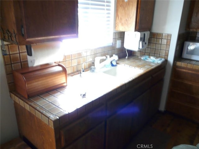 kitchen featuring tile countertops and decorative backsplash