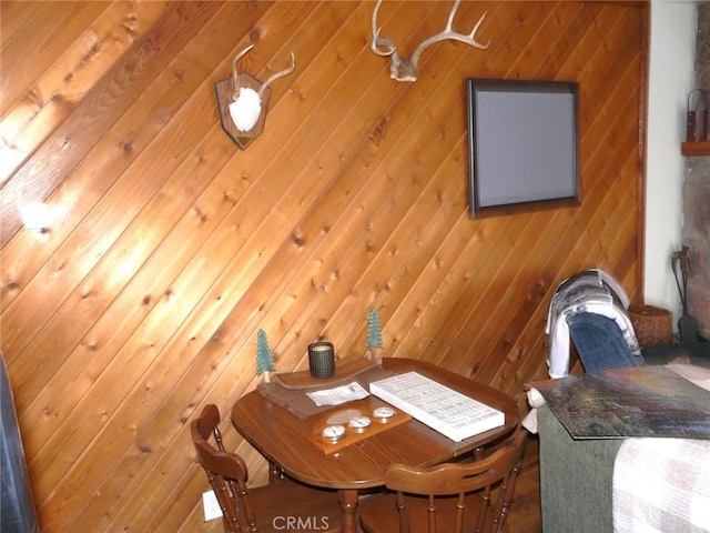 dining area featuring wood walls