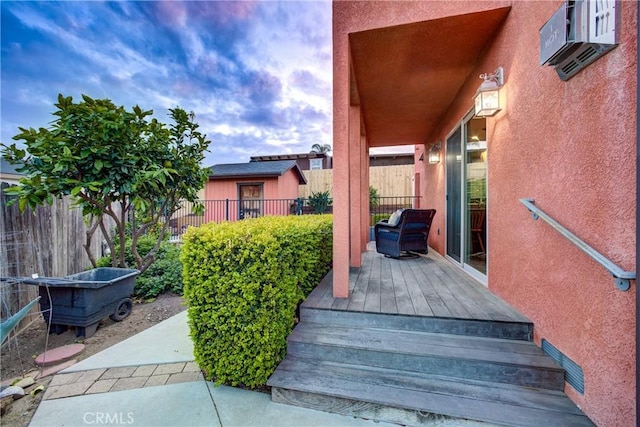 view of patio / terrace featuring a wooden deck and fence