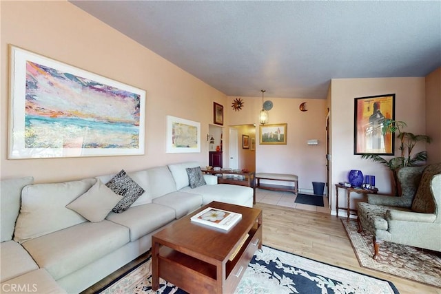 living room with lofted ceiling and light wood-style flooring