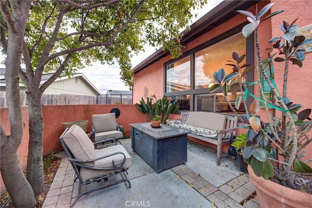 view of patio featuring an outdoor living space and fence