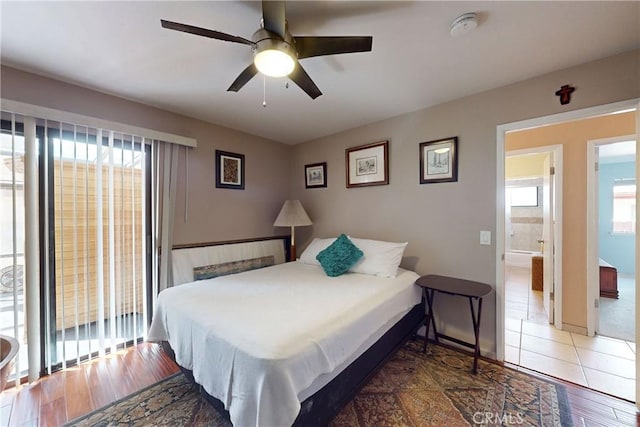 bedroom with connected bathroom, wood finished floors, and ceiling fan