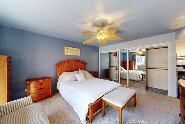 carpeted bedroom with multiple closets and ceiling fan