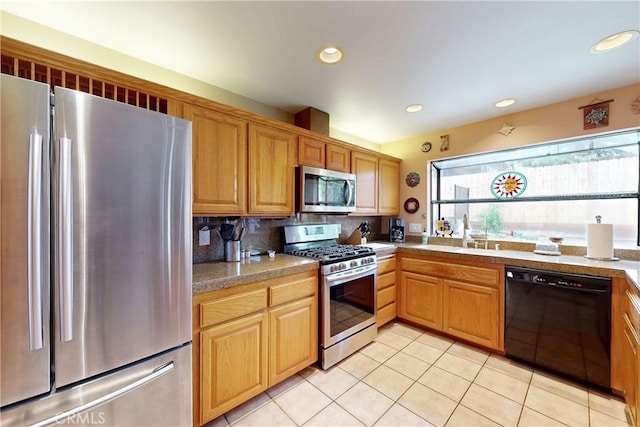 kitchen featuring tile countertops, light tile patterned floors, a sink, decorative backsplash, and stainless steel appliances