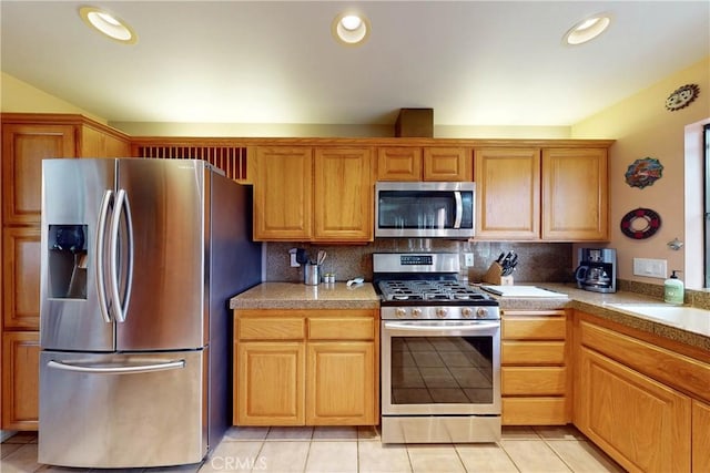 kitchen featuring light tile patterned floors, decorative backsplash, recessed lighting, and stainless steel appliances