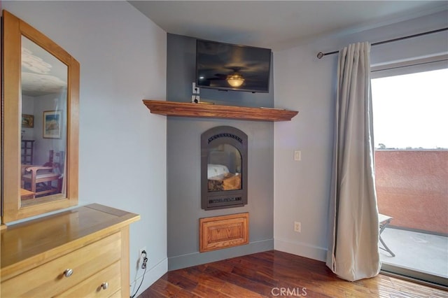 interior details featuring wood finished floors and baseboards