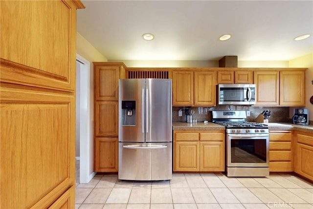 kitchen featuring light tile patterned floors, stainless steel appliances, recessed lighting, and decorative backsplash